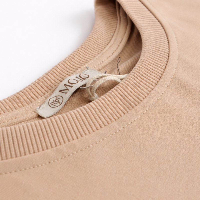 detal materiału komplet damski beżowy bawełniany bluzka krótki rękaw